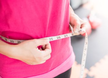Woman measuring waistline