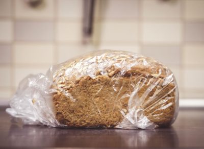 Loaf of bread on kitchen counter in plastic bag