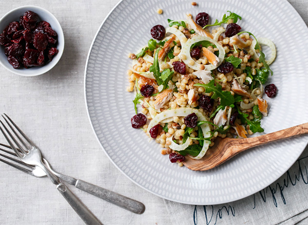 fregula salad on plate with fork and knife