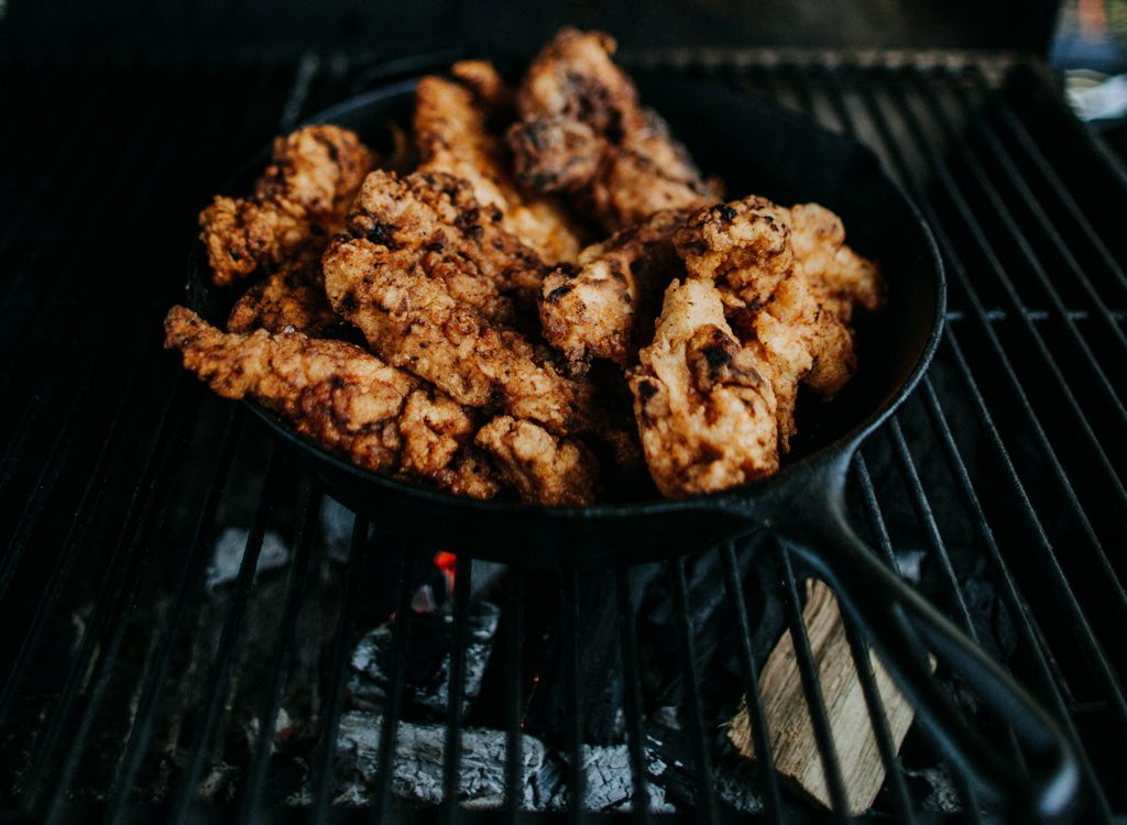Chicken grilling in cast iron skillet