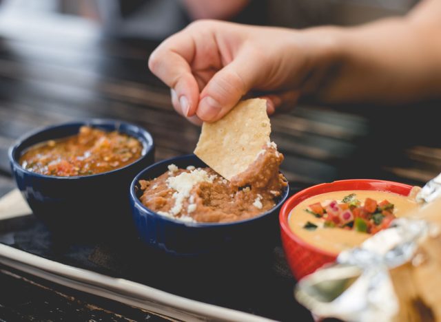 Dipping chip into bean dip