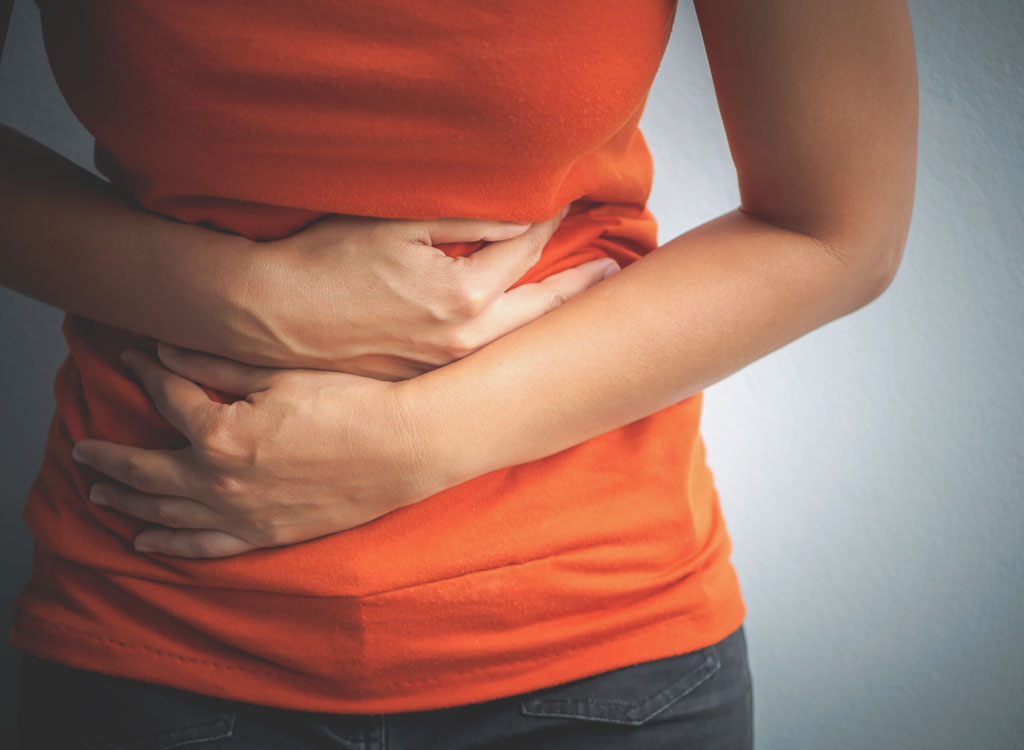 Woman holding stomach cramps digestive problems