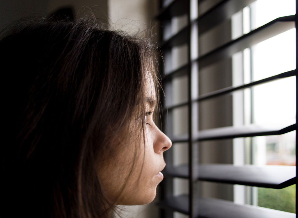 woman staring out window