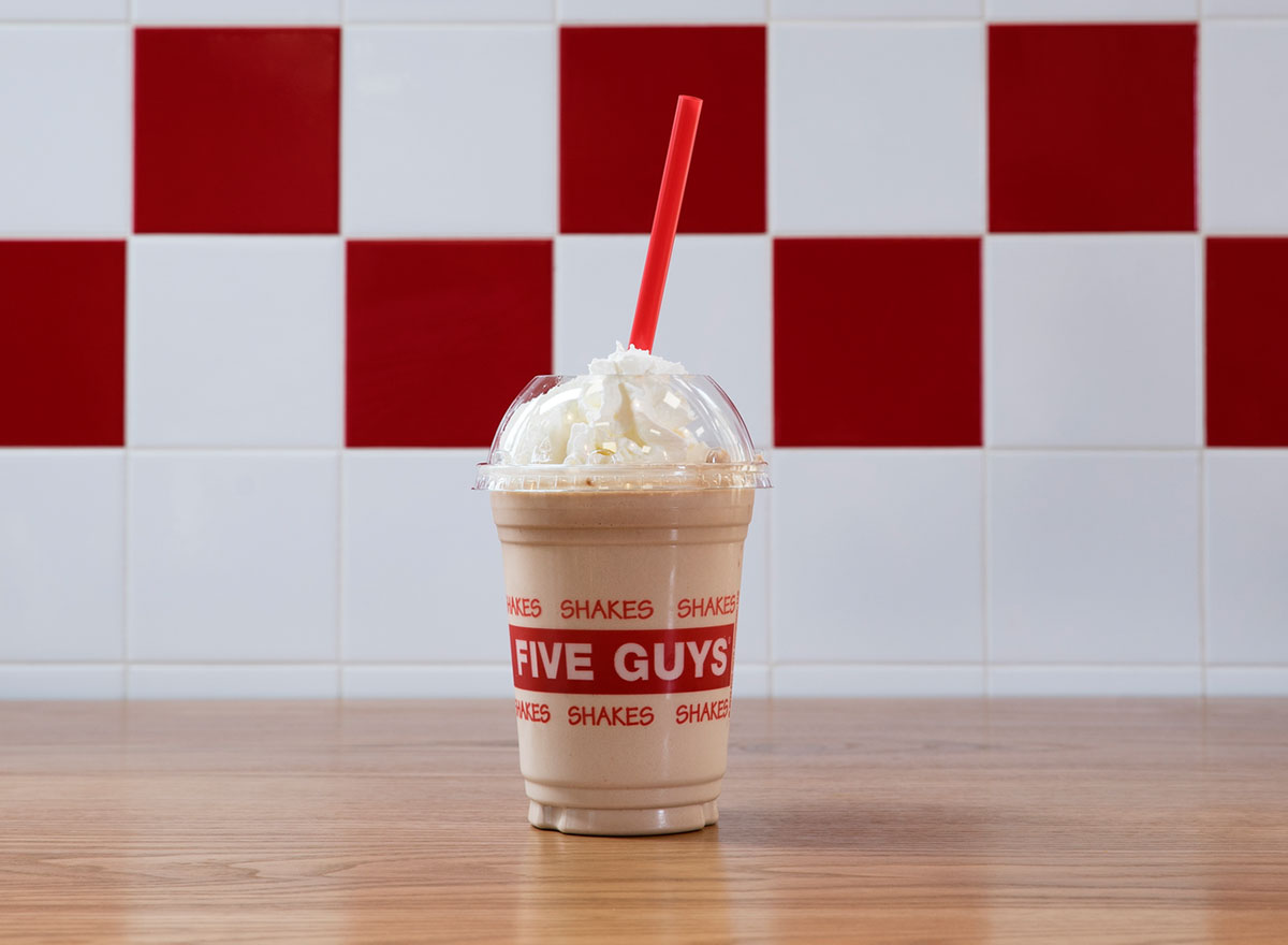 five guys chocolate milkshake with whipped cream and red straw