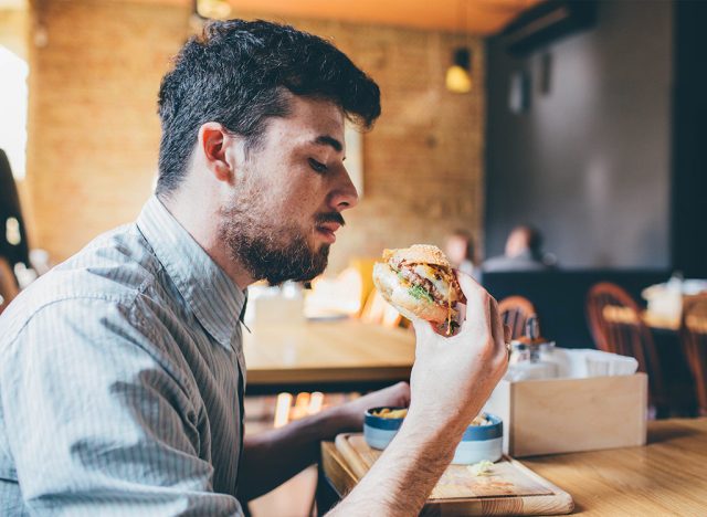 Guy eating at fast-food restaurant