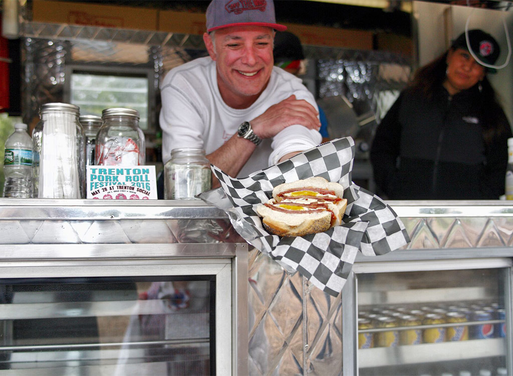 man handing pork roll out of food truck