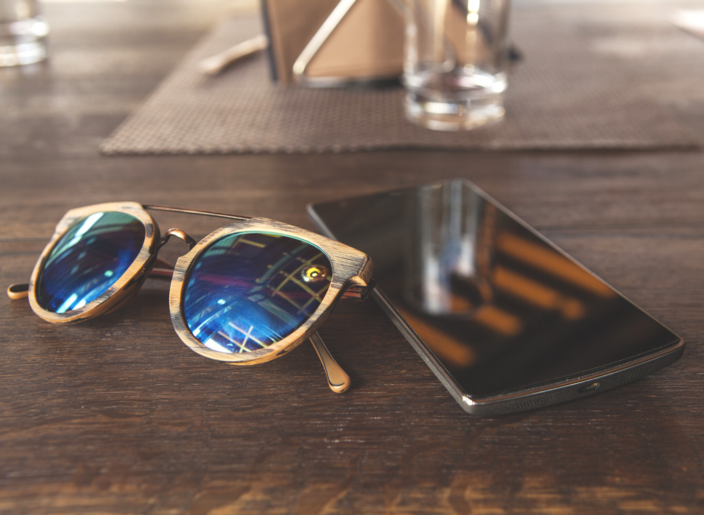 Phone sunglasses left on table