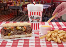 Portillos hotdogs and fries dipping in sauce