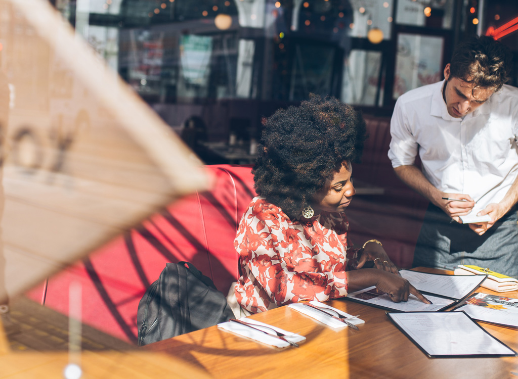 Waiter and customer at restaurant