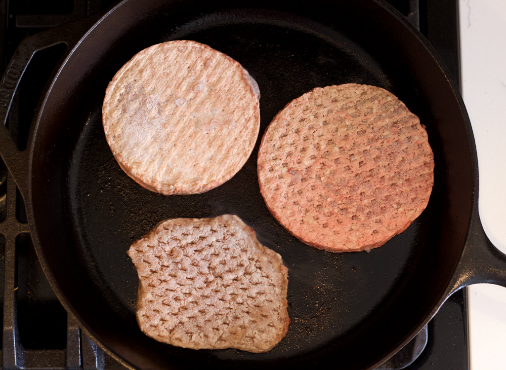 Frozen burgers in pan