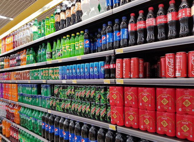 soda aisle with cans and bottles of soda