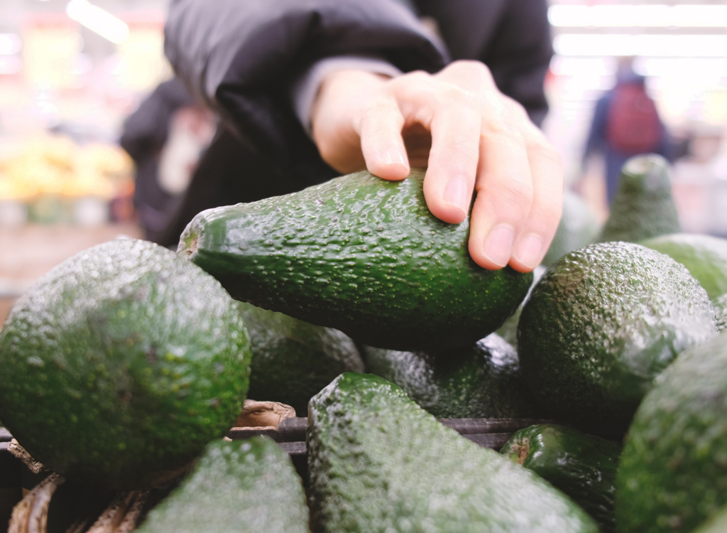 Pick avocado at grocery store