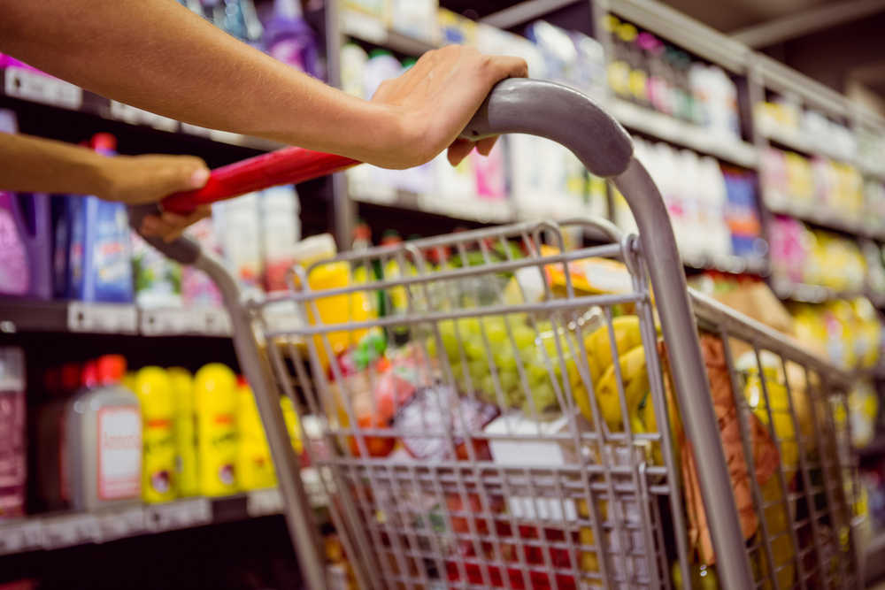 healthy foods weight loss woman pushes grocery cart in store