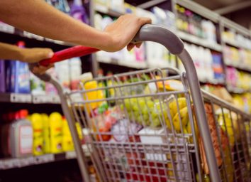 healthy foods weight loss woman pushes grocery cart in store
