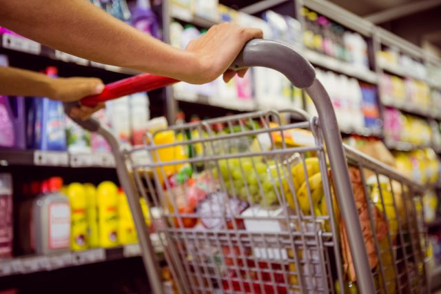 healthy foods weight loss woman pushes grocery cart in store