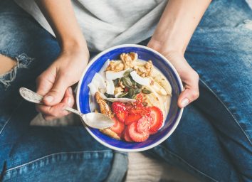 Womens healthy foods breakfast bowl strawberries grains yogurt
