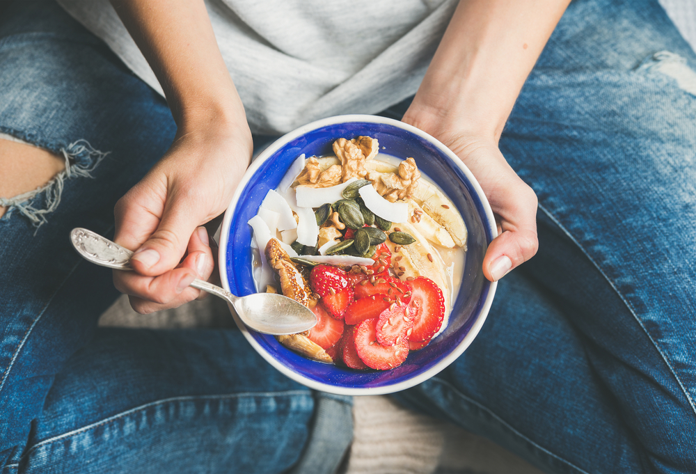 Womens healthy foods breakfast bowl strawberries grains yogurt