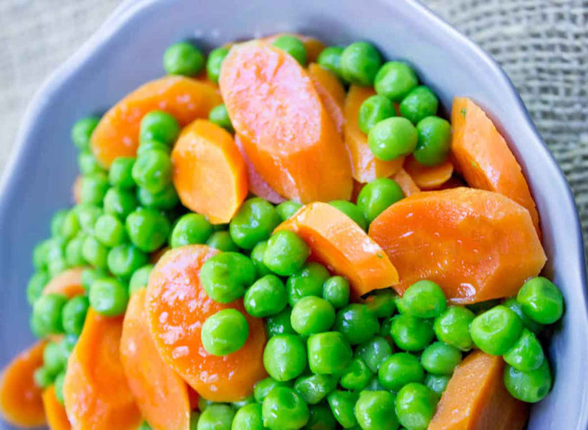 sliced carrots and peas in blue plate
