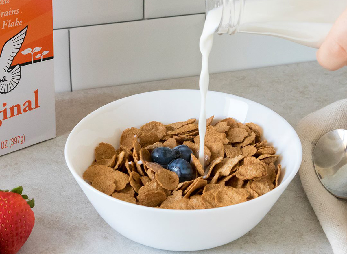 Ezekiel cereal in bowl with milk and fruit