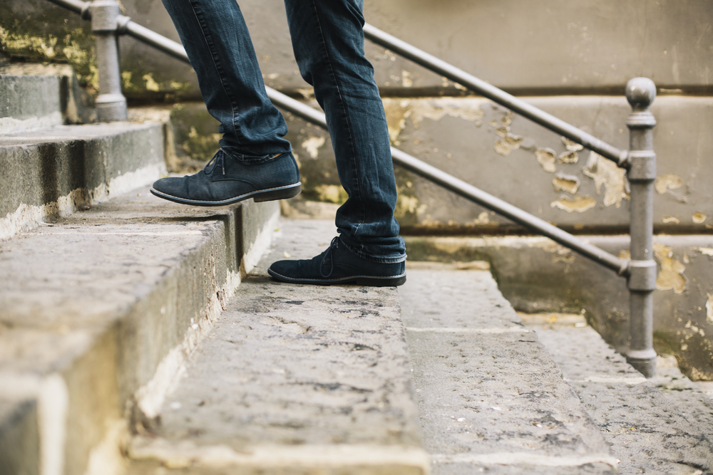 healthy habits man takes stairs outside - how to beat weight loss plateau