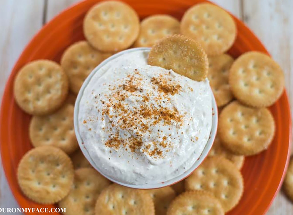 holiday crab dip with ritz crackers on orange plate