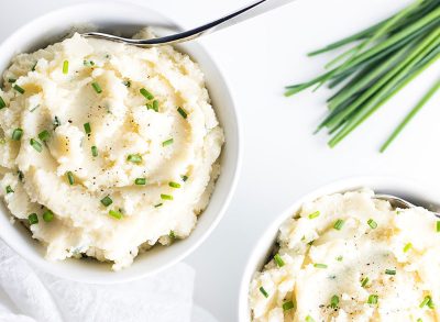keto cauliflower mash in two bowls with scallions