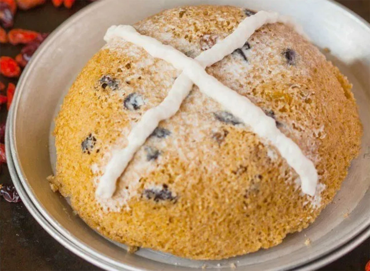 microwave hot cross bun with frosting on white plate