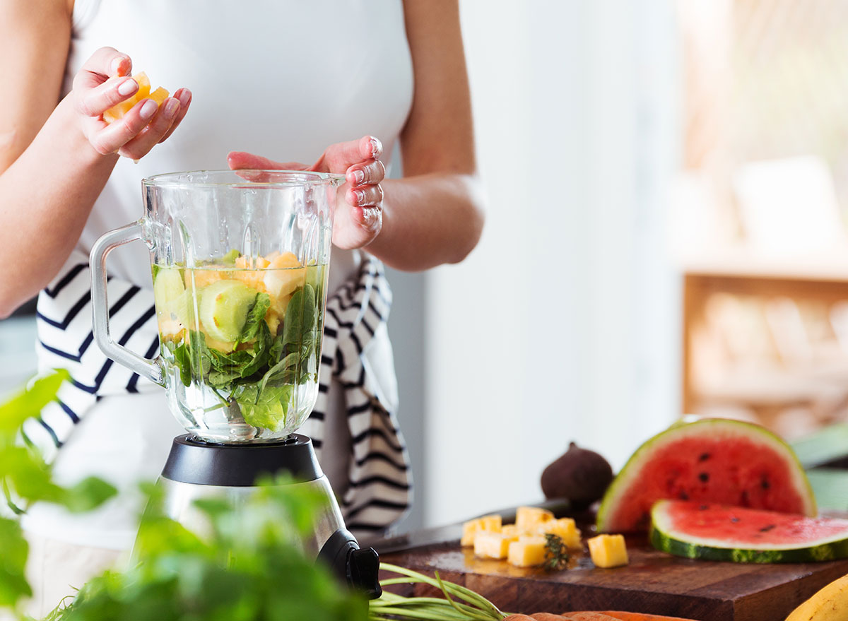 woman blending water and fruit