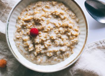 Bowl of plain oatmeal with milk for breakfast