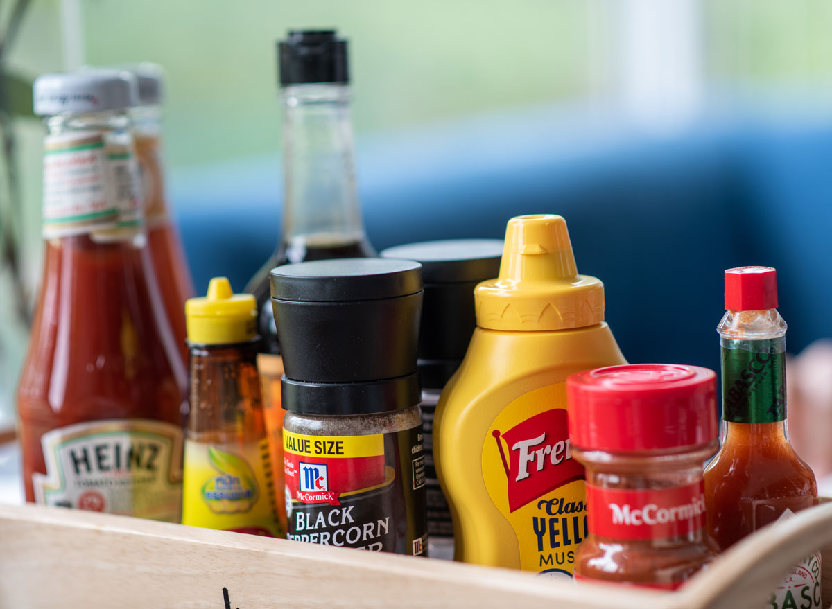 basket of condiments ketchup hot sauce mustard