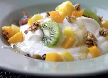 Gluten-free yogurt with pineapple kiwi mango and ginger syrup