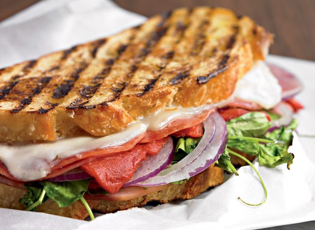 Italian panini with provolone and peppers and arugula