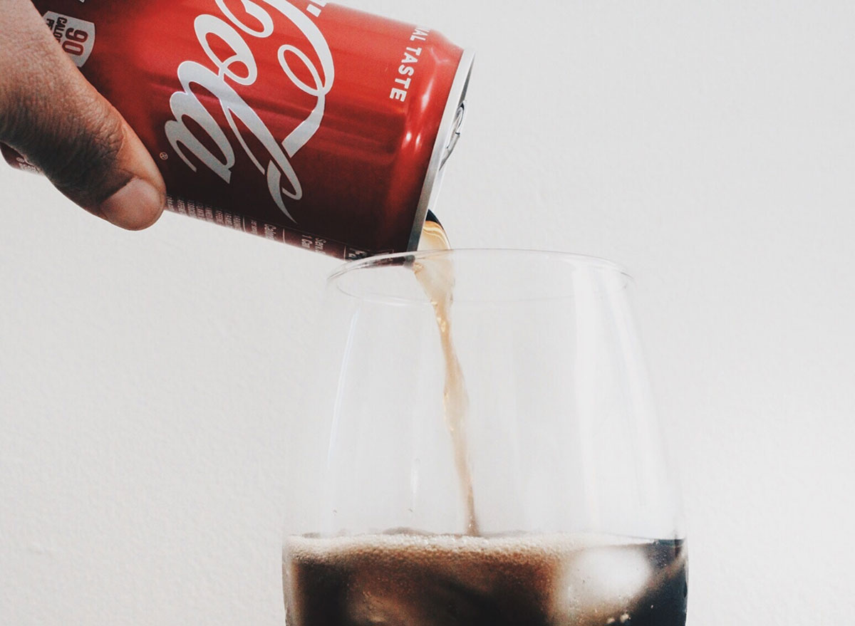 pouring soda into glass