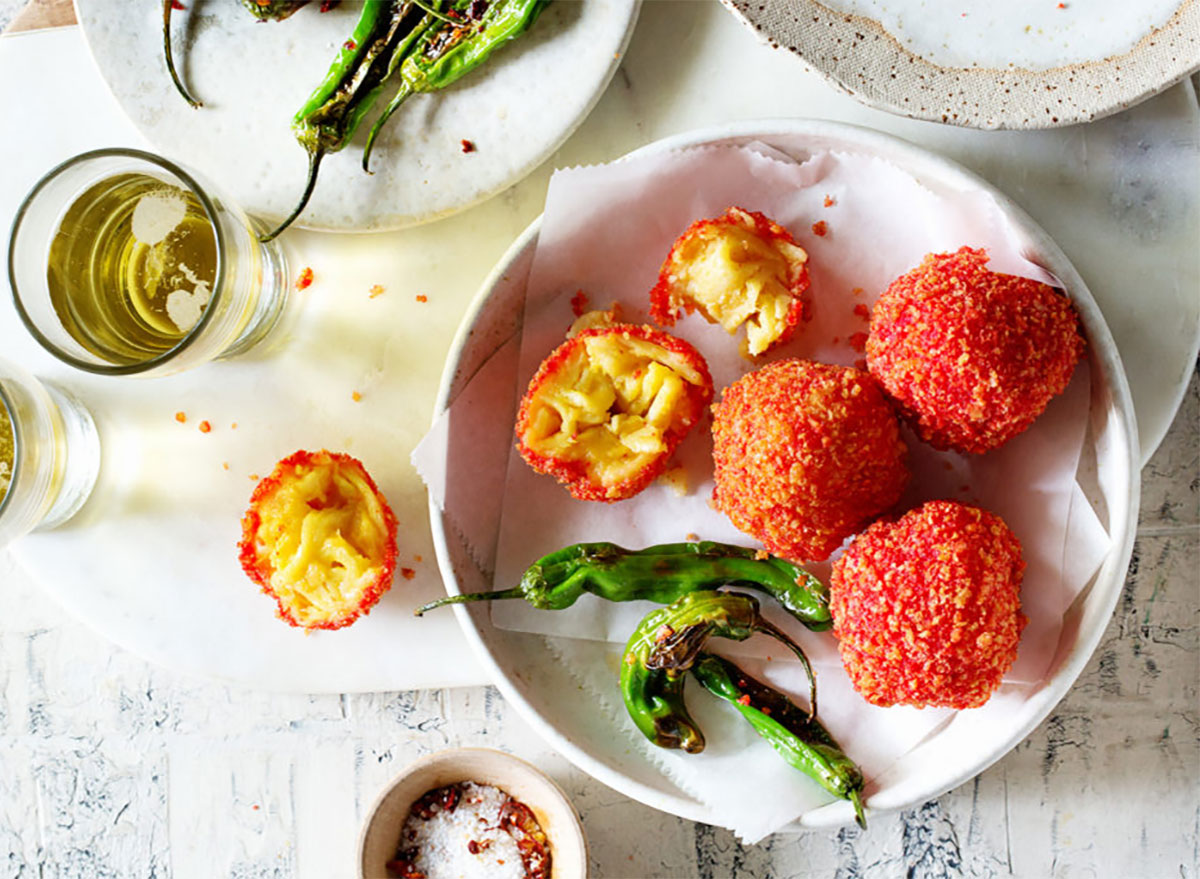 cheetos mac and cheese balls on plate with jalapeno peppers and drink