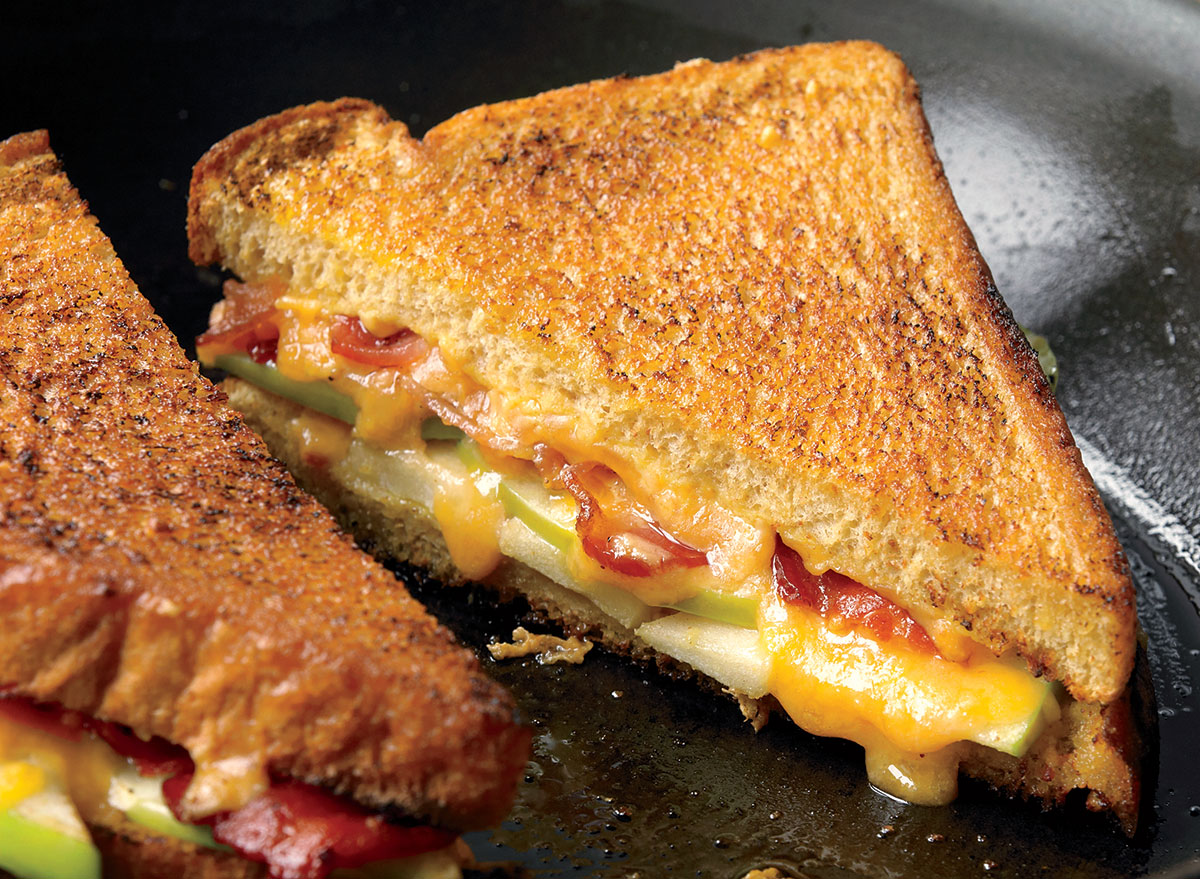 https://www.eatthis.com/wp-content/uploads/sites/4/2019/01/healthy-grilled-cheese-apples-bacon.jpg?quality=82&strip=1