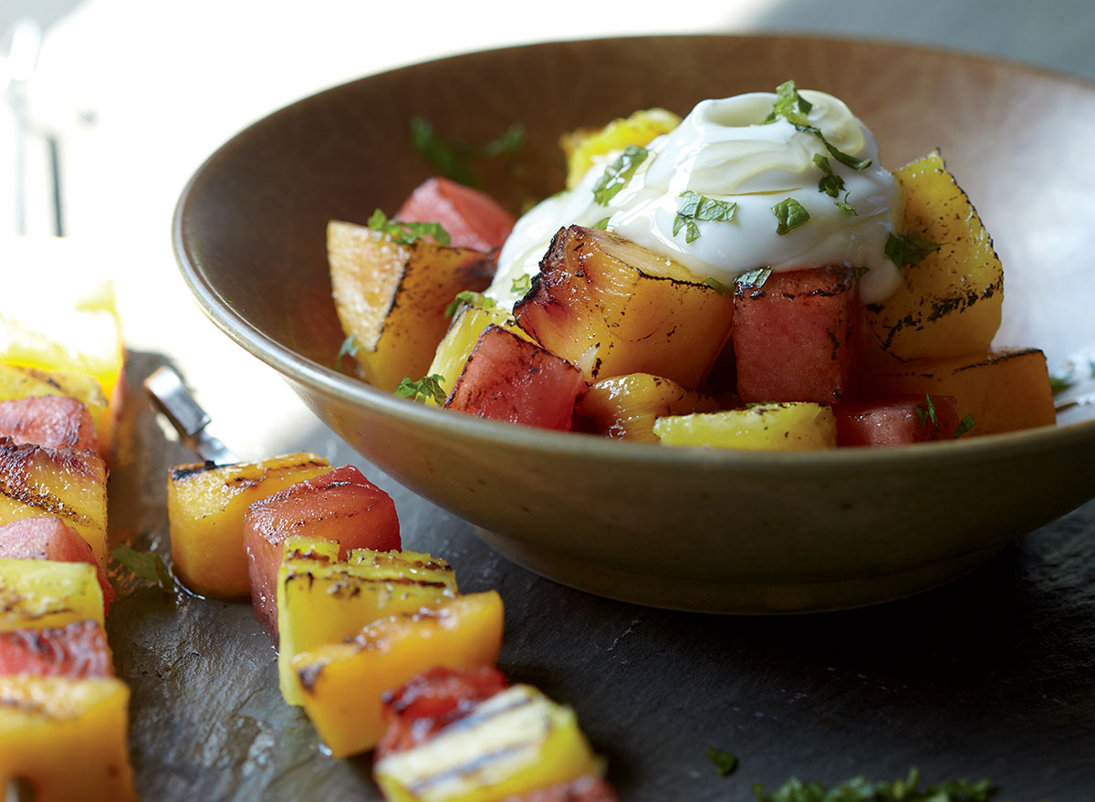 Healthy grilled fruit kebabs with yogurt and honey