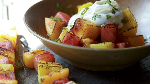 Healthy grilled fruit kebabs with yogurt and honey
