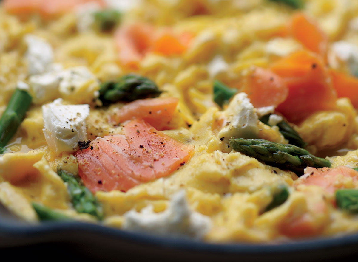 Healthy scrambled eggs with salmon asparagus and goat cheese