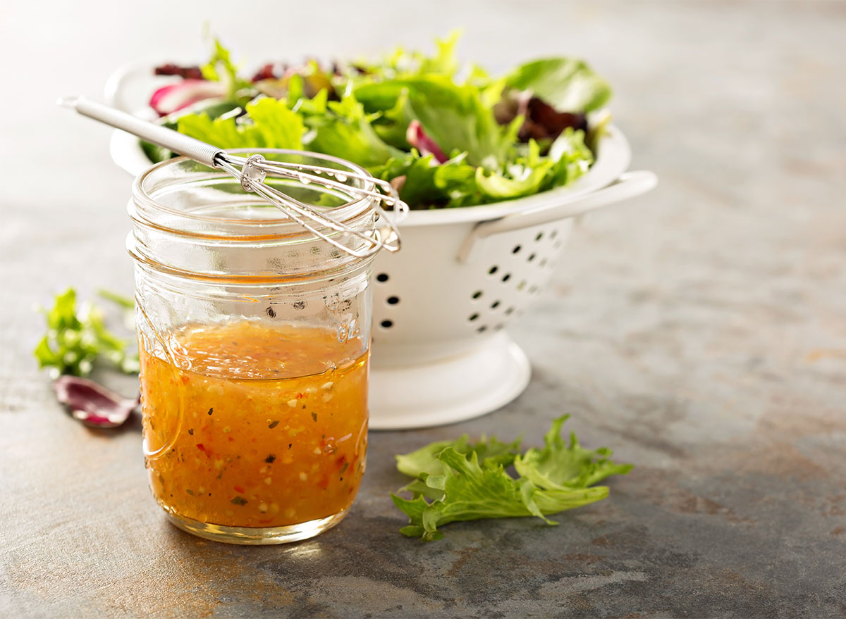 bottle of italian dressing with salad