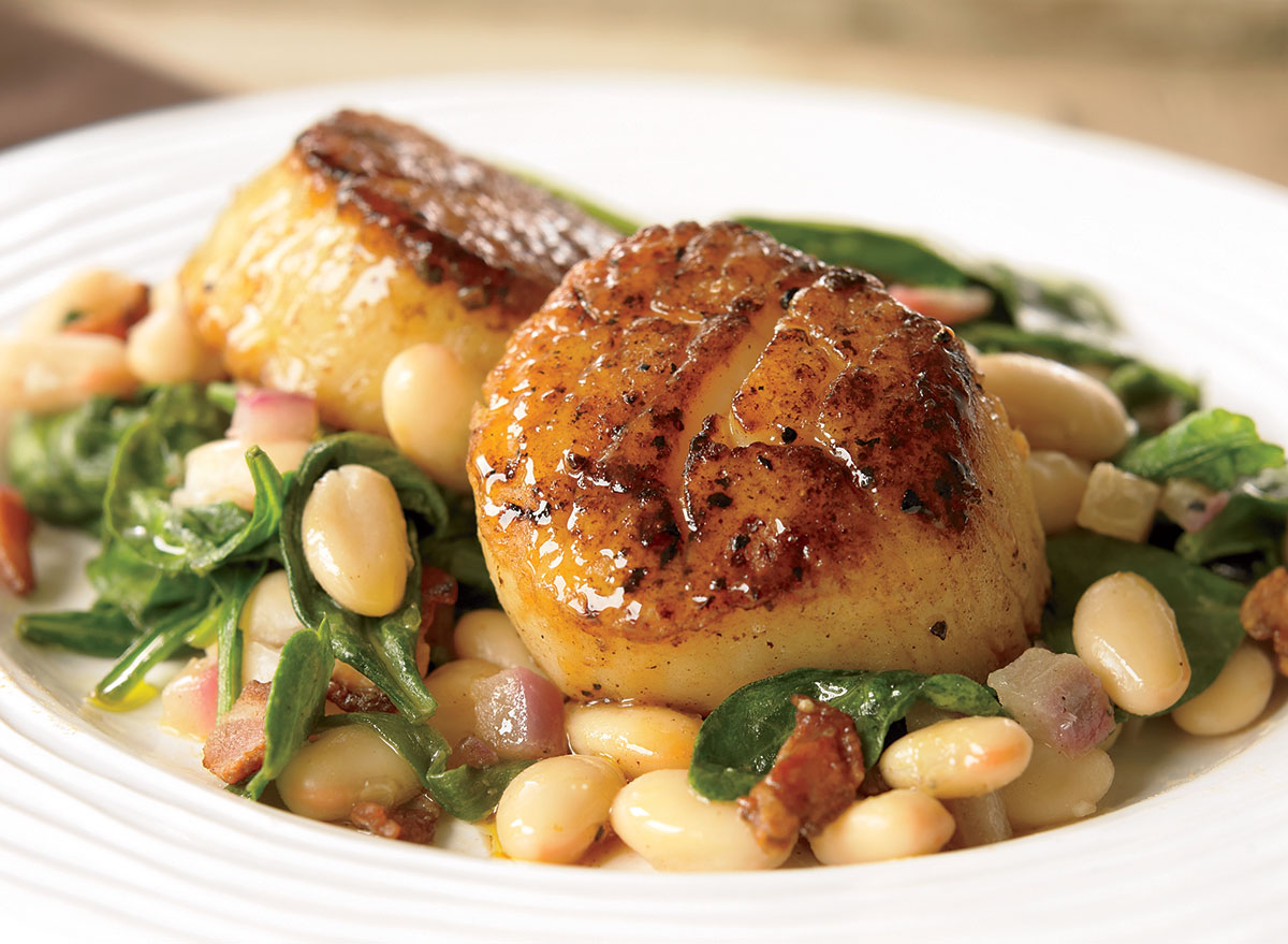 Seared scallops with white beans and spinach