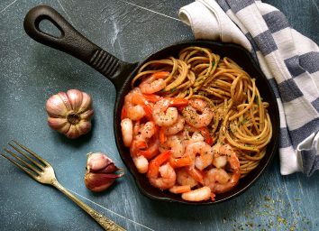 Shrimp and whole wheat spaghetti in cast iron pan