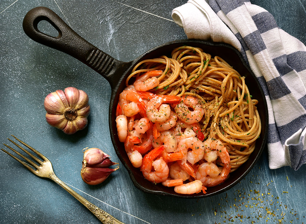 Shrimp and whole wheat spaghetti in cast iron pan