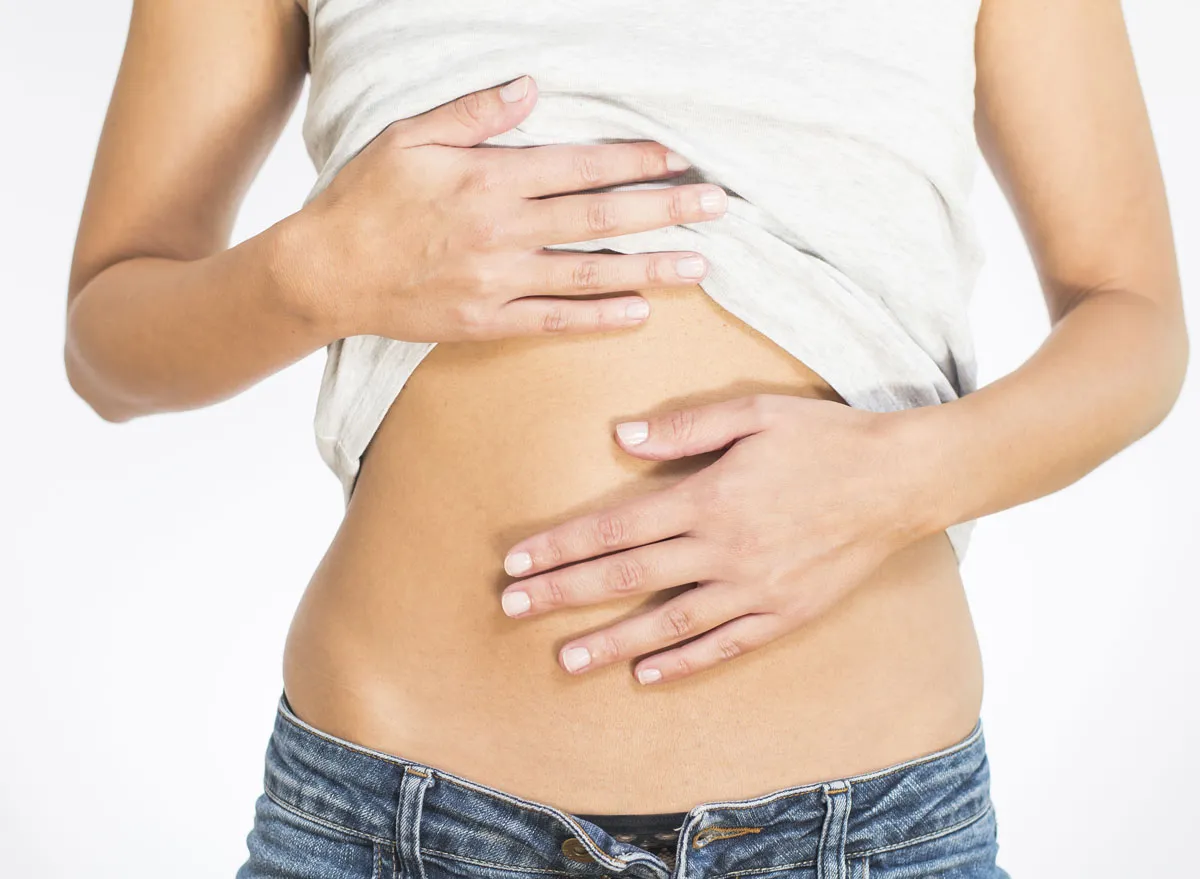 Woman holding a bloated upset stomach