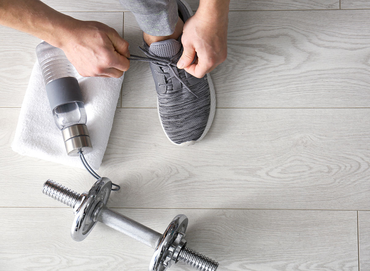 Man tying shoe before workout