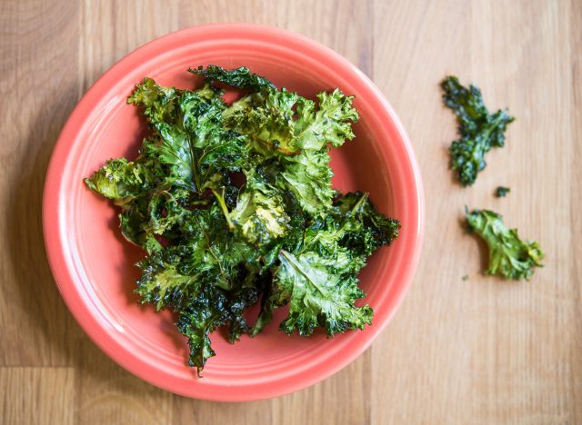 baked kale chips with olive oil and sea salt in an orange bowl