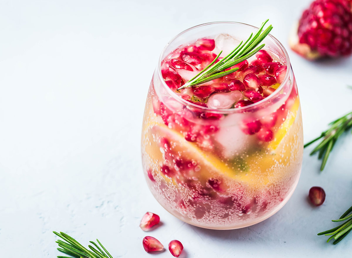 pomegranate lemon alcoholic seltzer mixed drink in small glass