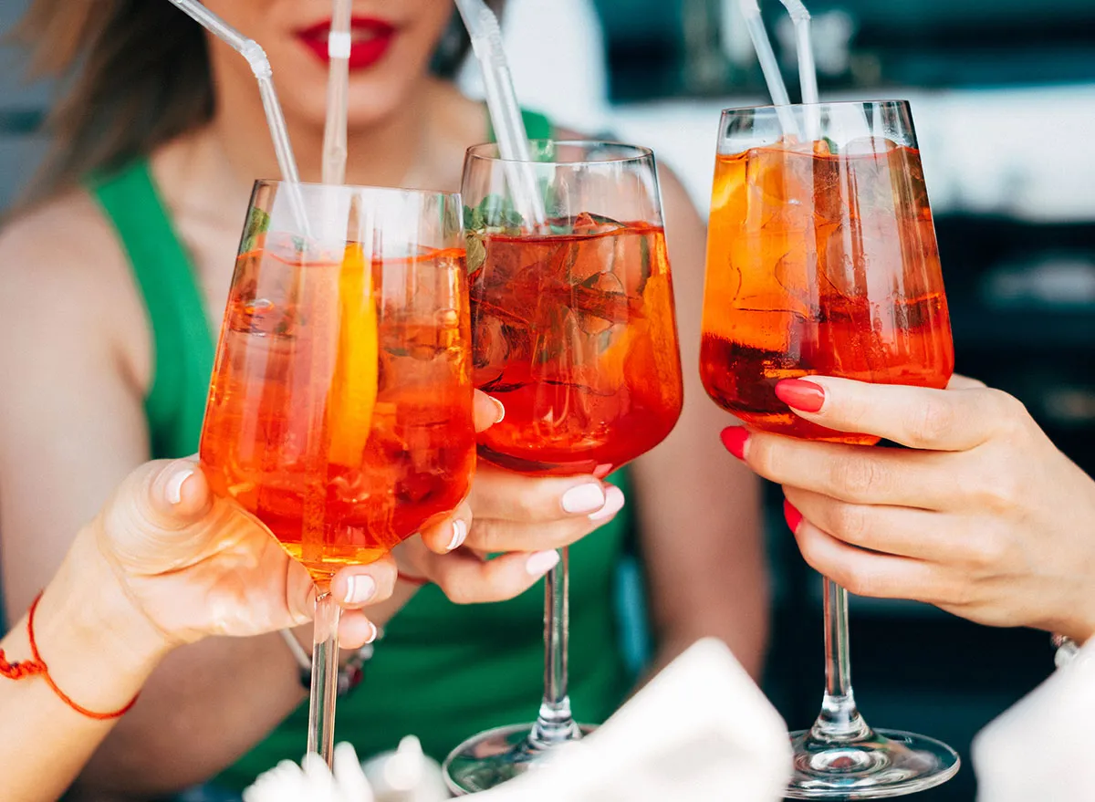 women holding aperol spritz cocktails - PCOS diet