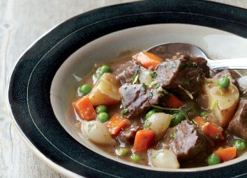 Beef stew recipe in black lined glass bowl