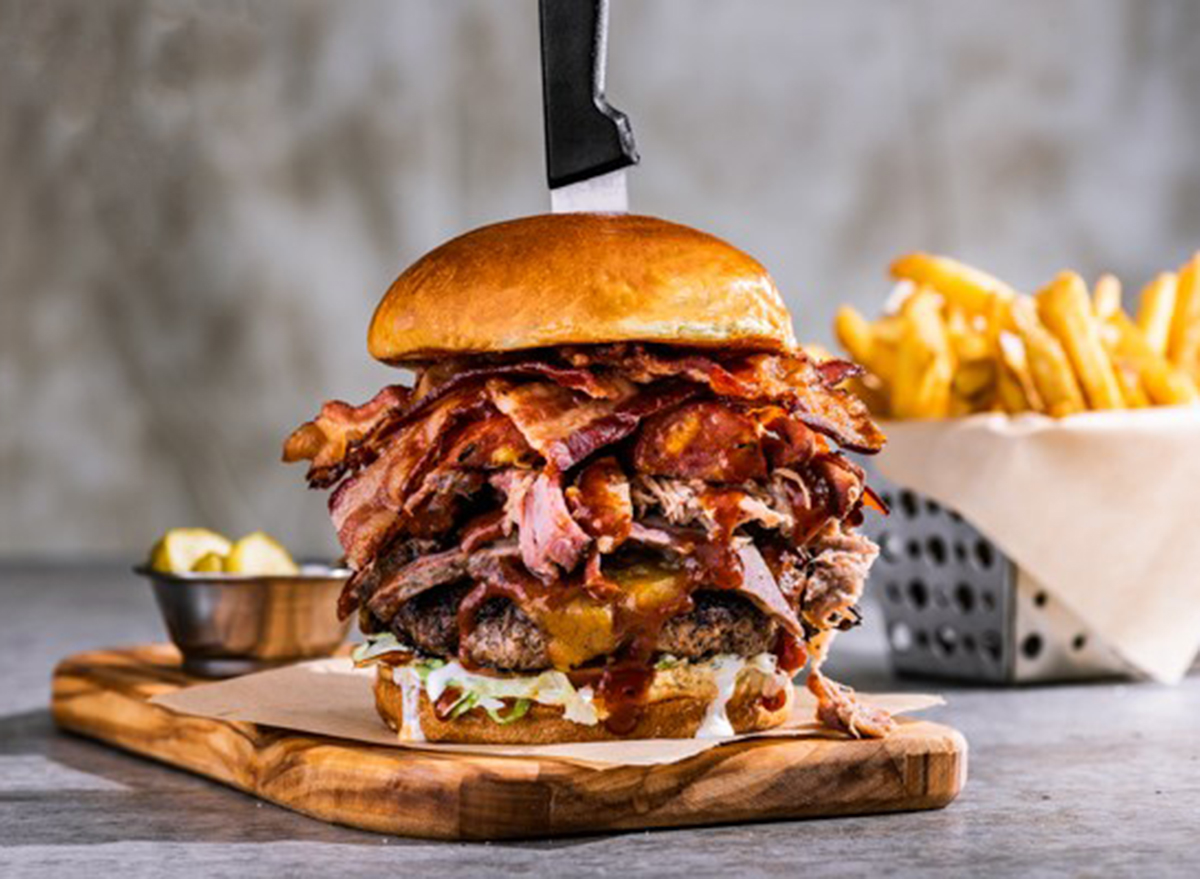 chilis boss burger with knife in top and fries basket