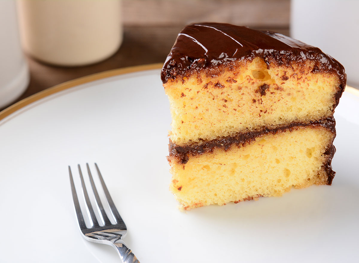 chocolate yellow cake slice with fork on plate